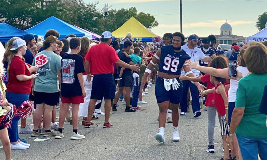 Community members and local athletes participating in a public event that demonstrates brand engagement, community connection, and audience interaction.