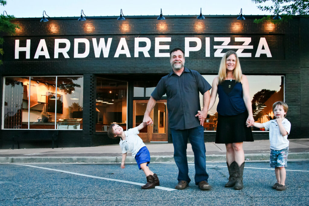 Local business owners standing outside a downtown restaurant representing the small businesses served by Z2A Marketing Solutions.